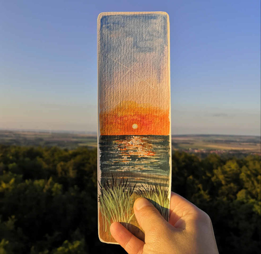 Aquarellmalerei in Form eines Lesezeichens zeigt Sonnenuntergang am Meer